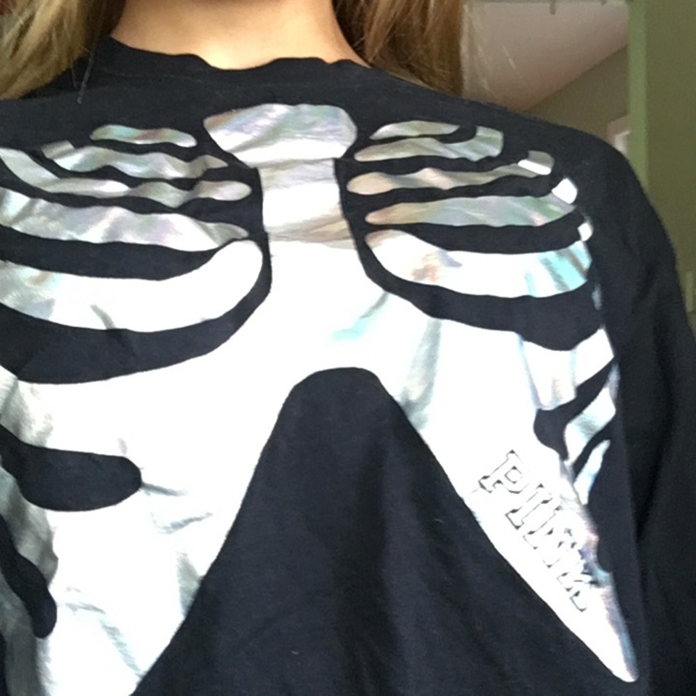 A black a holographic long sleeve cropped shirt.